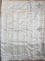 Pallu of golden white tissue silk saree
