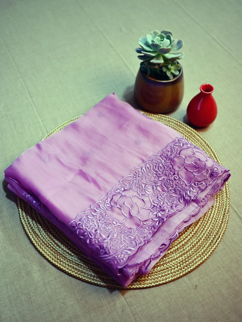 Lavender soft Organza saree with embroidery along the border and pallu.