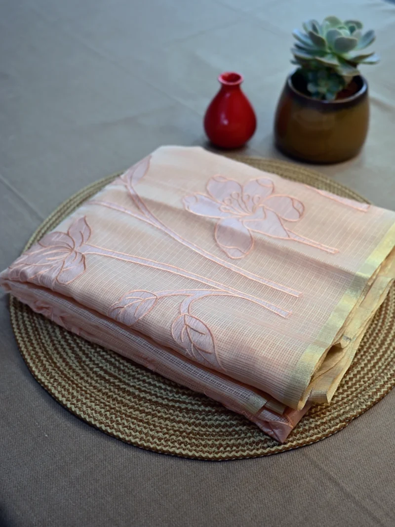 Peach colour Kota cotton saree with applique work.