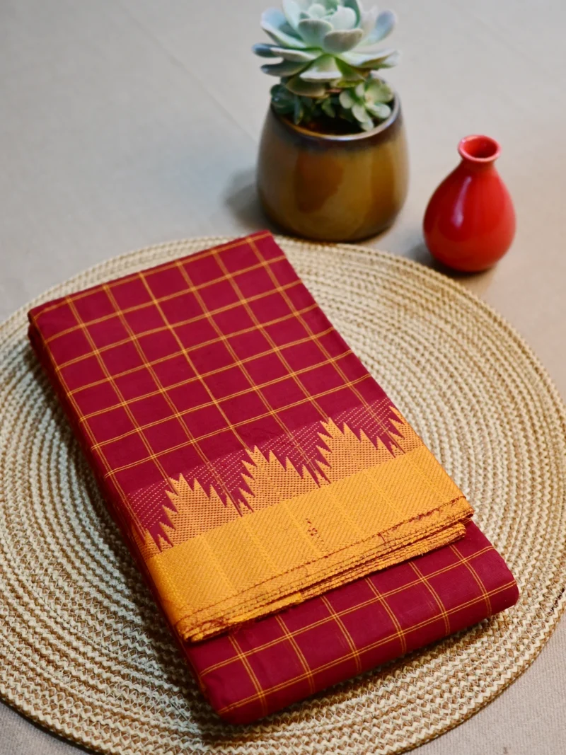 Brown cotton saree with yellow border.