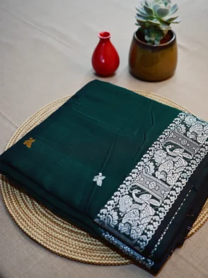Green cotton Baluchari saree with white border.
