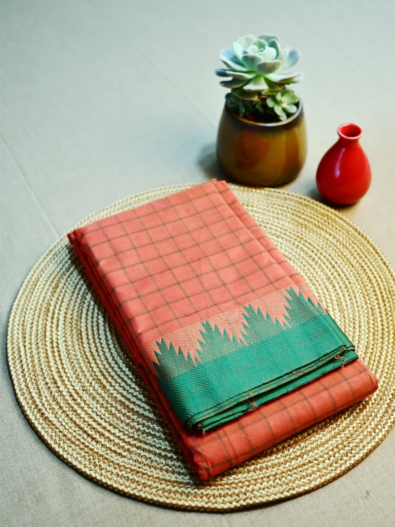 Peach colour cotton saree with green border.