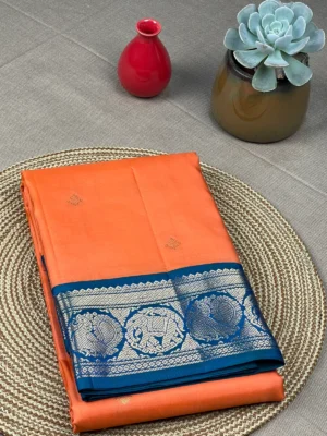 Peach colour pure Kanchipuram silk saree with peacock blue border