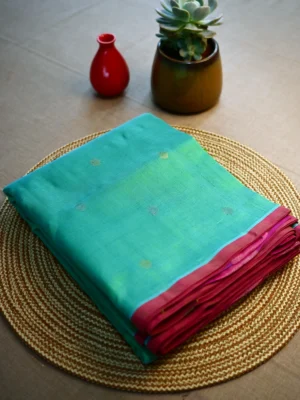 Sea green silk cotton saree with small red border and golden butti