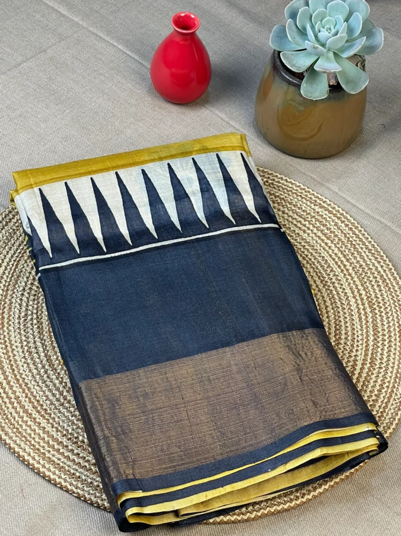 Yellow pure Tussar silk saree with black border.