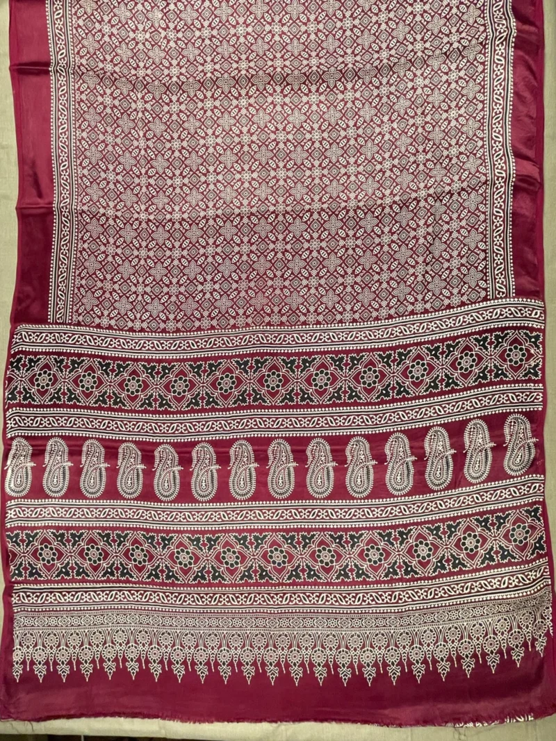 Pallu of maroon printed modal saree