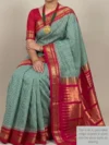 Mannequin wearing green small checks pure silk Ilkal saree