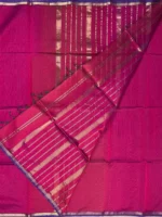 Blouse of A silk‑cotton Maheshwari saree with shades of magenta, blending heritage and modern elegance. The beauty of plain saree is accentuated by a narrow blue border with golden jari. A coordinated pallu highlights its elegance. Paired with a matching blouse piece, it’s a luxurious, tasteful choice for festive occasions and family gatherings.