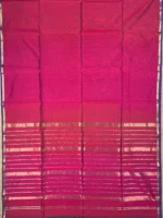 Pallu of A silk‑cotton Maheshwari saree with shades of magenta, blending heritage and modern elegance. The beauty of plain saree is accentuated by a narrow blue border with golden jari. A coordinated pallu highlights its elegance. Paired with a matching blouse piece, it’s a luxurious, tasteful choice for festive occasions and family gatherings.